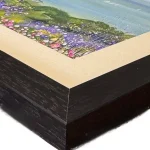 alum bay, the corner of a print in a black frame by Isle of Wight artist Julia Tanner