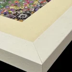 summer at the needles, the corner of a print in a white frame by Isle of Wight artist Julia Tanner