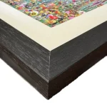 summer meadow, the corner of a print in a black frame by Isle of Wight artist Julia Tanner