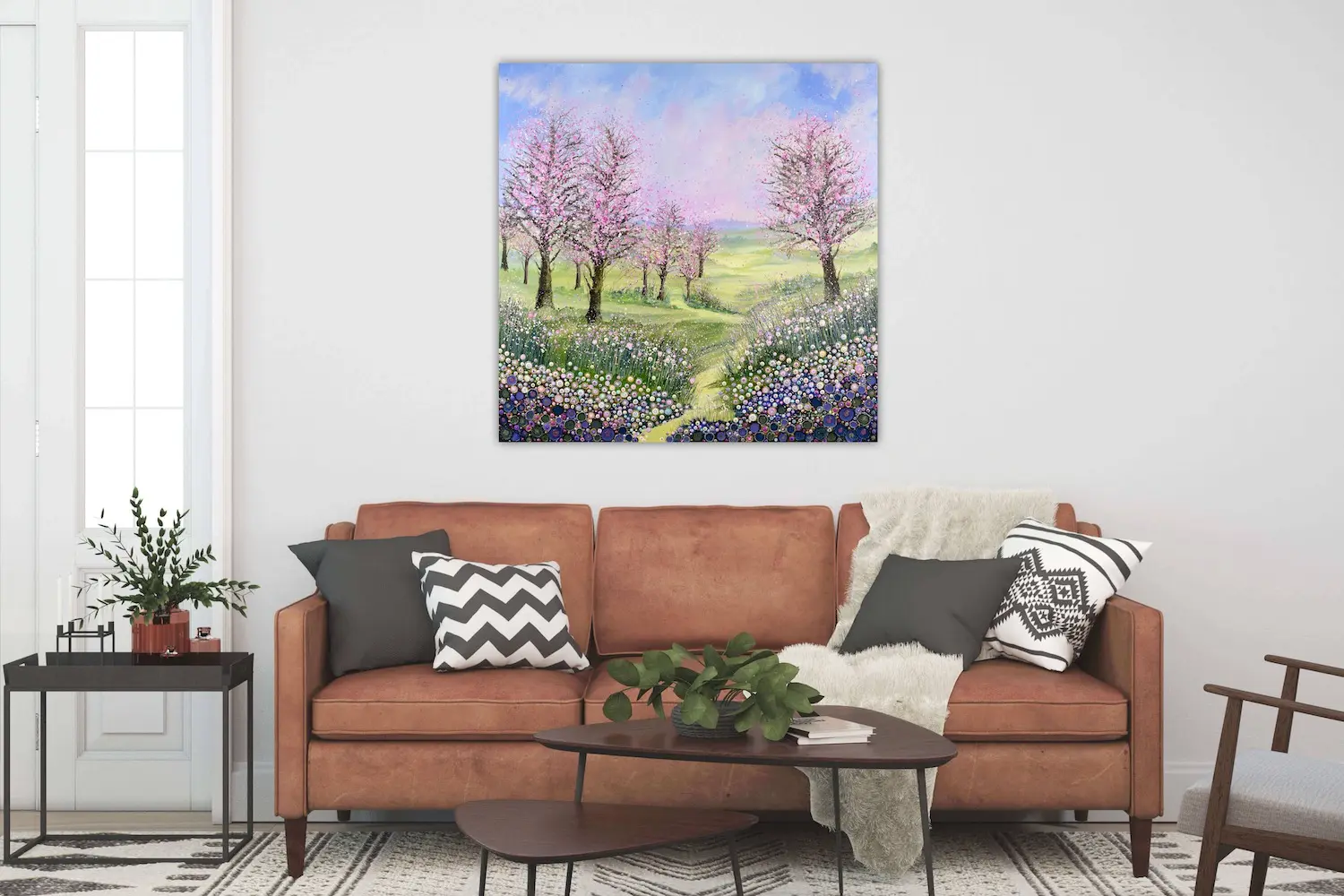 A large canvas print of cherry blossom - an original painting by Julia Tanner art - hanging on a wall in the lounge