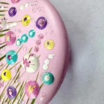 side view of pretty in pink round flower meadow brooch by Julia Tanner