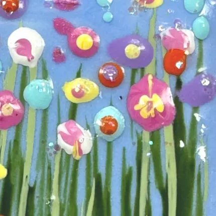 the detail of flowers on a blue hand painted meadow necklace by Julia tanner