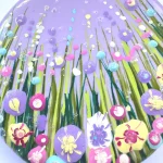details of the flowers on a round lilac flower meadow brooch