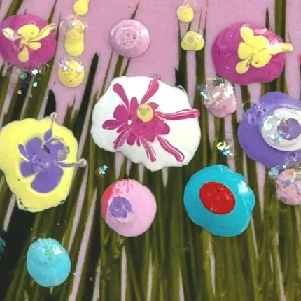 close up of flowers on a pink brooch by Julia tanner