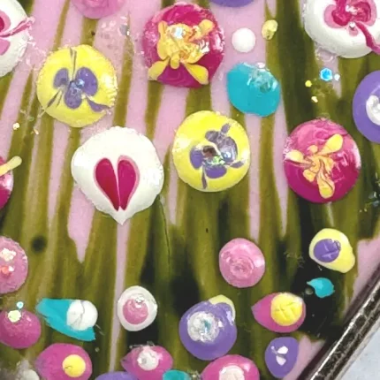 close up of flowers on a pink flower meadow pendant by Julia tanner