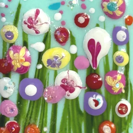 close up of the flowers on a turquoise pendant