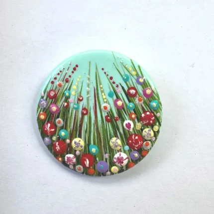 a round turquoise flower brooch by Julia Tanner art